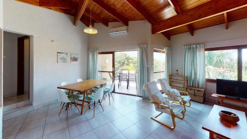 a living room with a wooden table and chairs at San Lameer Villa 1931 by Top Destinations Rentals in Southbroom