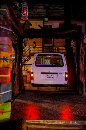a white car parked in a garage at night at Belljem Homes -your own private resort -6 BHK S in Trichūr