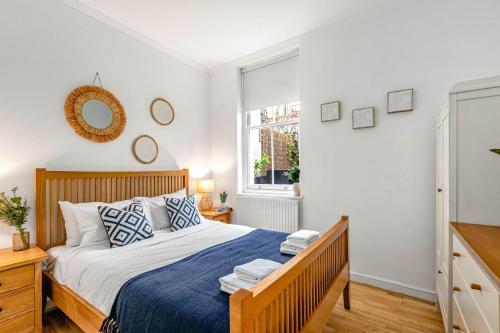 a bedroom with a large bed and a window at Cozy Covent Garden/Oxford Street apartment in London