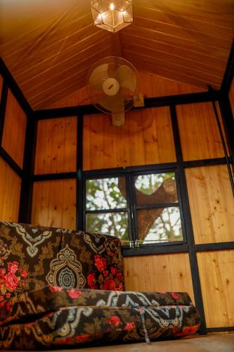 a ceiling fan and a couch in a room at Belljem Homes -your own private resort -6 BHK S in Trichūr