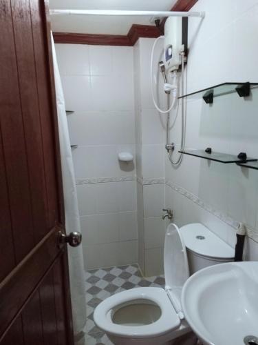 a small bathroom with a toilet and a sink at Isabelle Garden Villas 828 in Manila