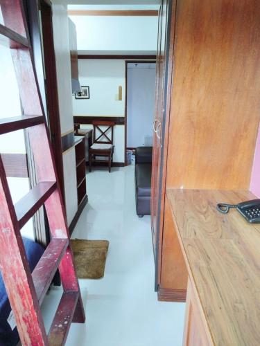 a room with a wooden door and a room with a table at Isabelle Garden Villas 828 in Manila