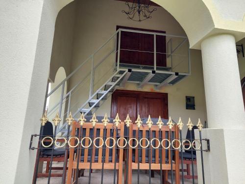a building with a staircase and a wooden door at Patak Üdülőház (Ferienhaus) in Nagyvisnyó