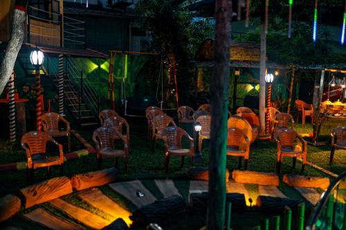 a group of chairs and tables in a yard at night at Belljem Homes -your own private resort -6 BHK S in Trichūr
