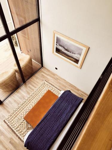 a living room with a bed and a mirror at Khoj Resorts Shigar in Shigar