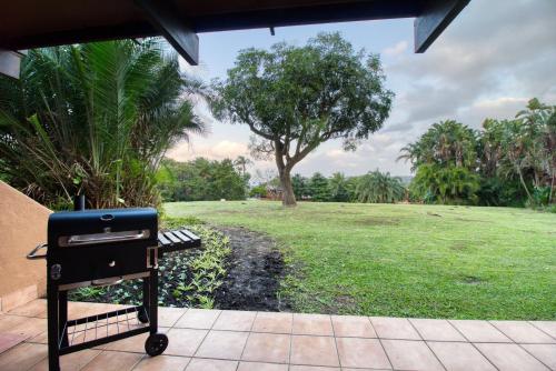 a grill sitting on a porch with a park at San Lameer Villa 2502 by Top Destinations Rentals in Southbroom