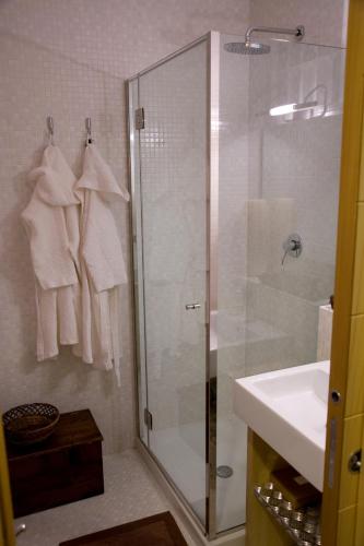 a bathroom with a glass shower and a sink at garibaldi citta' in Trapani