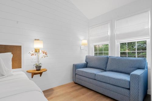 a bedroom with a blue couch and a bed at Nantucket Inn in Nantucket