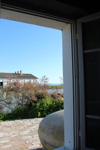 a sliding glass door with a view of a patio at CASA VACANZE “ LA TERRAZZA “ in Comacchio