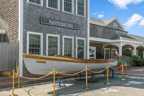 a boat on display in front of a building at Nantucket Inn in Nantucket
