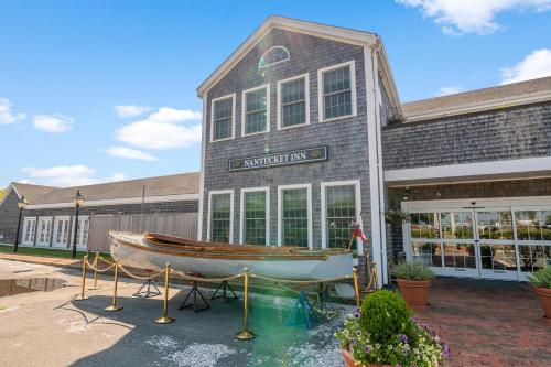 a boat on display in front of a building at Nantucket Inn in Nantucket