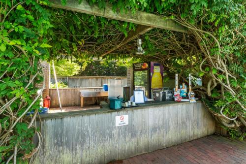 a bar with vines growing on a fence at Nantucket Inn in Nantucket