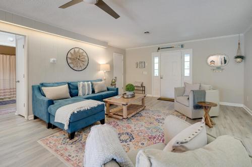 a living room with a blue couch and chairs at Oak Island Home with Spacious Backyard and Porch in Oak Island
