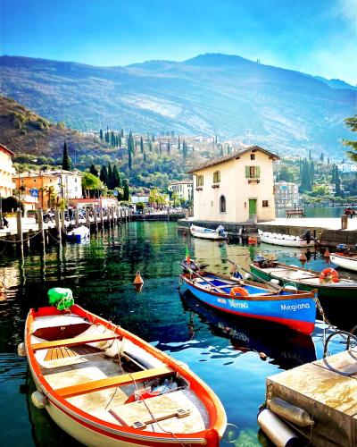 a group of boats are docked in a harbor at Outdooredo Garda Torbole in Nago-Torbole
