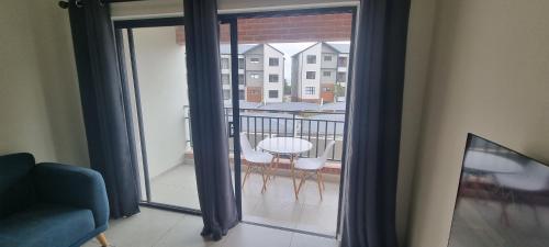 a view of a balcony with a table and chairs at The Aura in Roodepoort