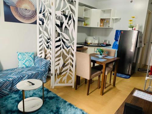 a living room with a table and a kitchen at Condo in Avida tower IT park , Lahug Cebu city, Fully furnished in Cebu City