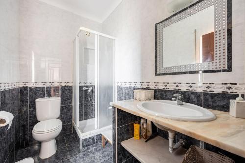 a bathroom with a toilet and a sink at Local Guesthouse in Sagres