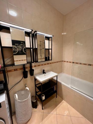 a bathroom with a sink and a bath tub at Condo Casa Di Olivia in Maribor