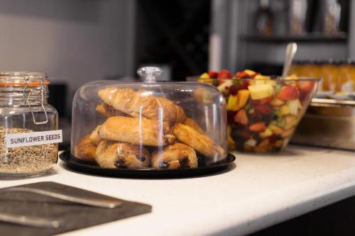 a plate of food in a glass container on a counter at The Angel Hotel in Leamington Spa