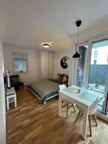 a bedroom with a bed and a table in a room at LA Studio in Maribor