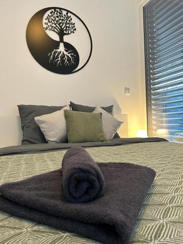 a bedroom with a bed with a towel on it at LA Studio in Maribor