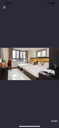 a hotel room with a bed and a desk at Tokia hotel nha trang in Nha Trang