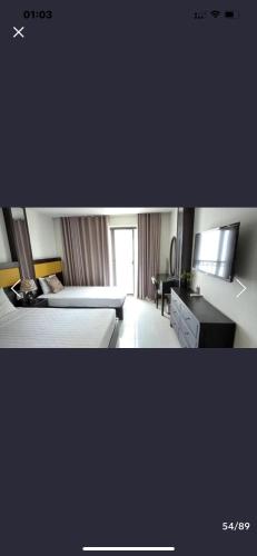 a hotel room with a bed and a desk at Tokia hotel nha trang in Nha Trang