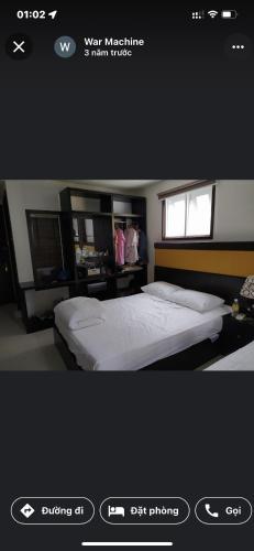 a bedroom with a white bed and a window at Tokia hotel nha trang in Nha Trang