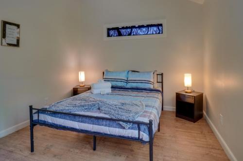 a bedroom with a bed and two lamps on tables at Charming Byrdstown Home with Fire Pit Near Lake in Byrdstown