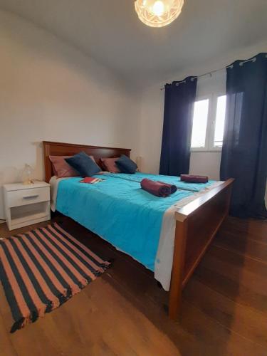 a bedroom with a large bed with blue sheets at App Goga in Umag