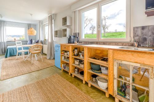 a kitchen with a counter and a sink and a table at Ausblick Maisenbach in Bad Liebenzell