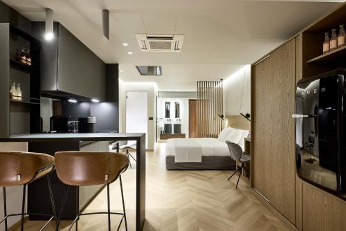 a kitchen and a bedroom with a bed in a room at Icon Suite in Athens