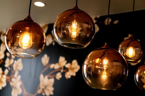 a bunch of lights hanging from a ceiling at 【Oyado道】貸切露天風呂付！別荘感覚で新築一軒家まるごと貸し切り１日１組限定！ハウステンボス近く in Hayaki