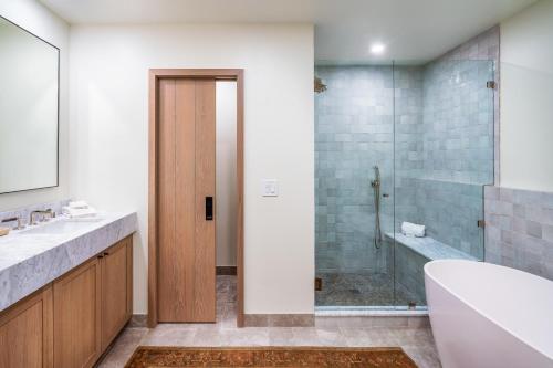 a bathroom with a tub and a sink and a shower at Creekside at Beaver Creek in Beaver Creek
