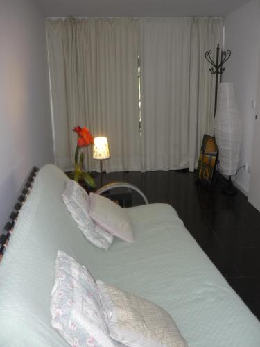 a bedroom with a bed with pillows on it at Casa da Terra in Góis