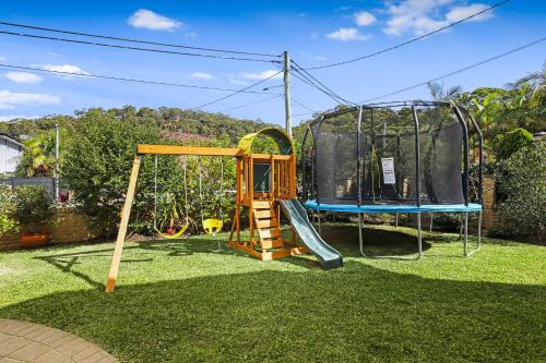 a playground with a slide and a swing set at Heated Pool, Beach Side Entetainer, Sleeps 18 in Umina