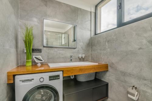 a bathroom with a washing machine and a sink at Luxury Villa Weiss - Malinska - heated Pool in Malinska