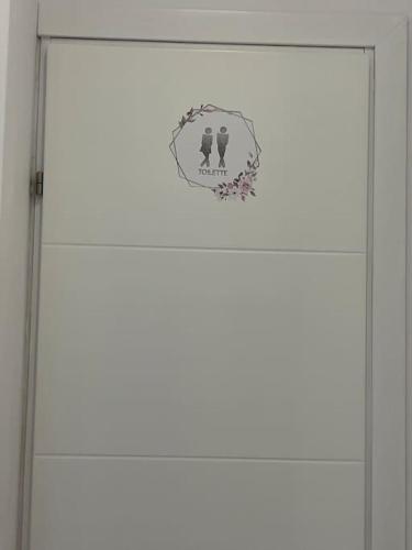 a white door with a sign on it at HOME OF OLYMPOS in Litochoro