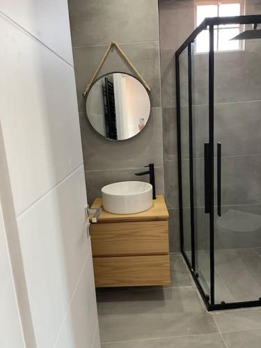 a bathroom with a sink and a mirror at HOME OF OLYMPOS in Litochoro