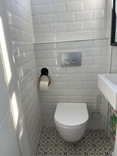 a white bathroom with a toilet and a sink at HOME OF OLYMPOS in Litochoro