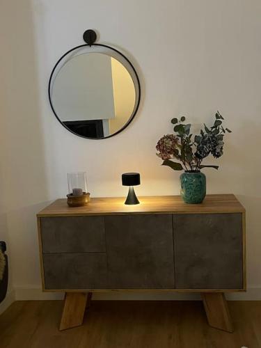 a mirror on top of a dresser with a plant on it at HOME OF OLYMPOS in Litochoro