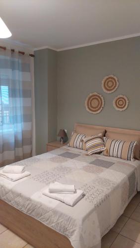 a bedroom with a large bed with towels on it at La bella casa thassos in Limenas