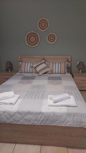 a large bed with two white towels on it at La bella casa thassos in Limenas