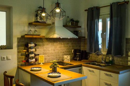 a kitchen with a counter with a sink and a stove at Golden Mile STUDIO-APARTMENT in Ýpsos
