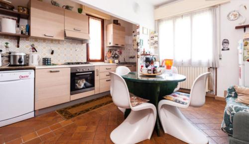 uma cozinha com mesa e cadeiras num quarto em Maison De Dora em San Giuliano Terme