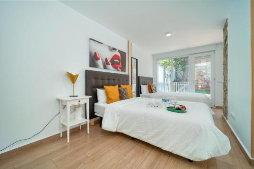 a bedroom with a bed with a tray of fruit on it at A CASACAFÉ Madrid Pozuelo Estación Private Rooms in Pozuelo de Alarcón