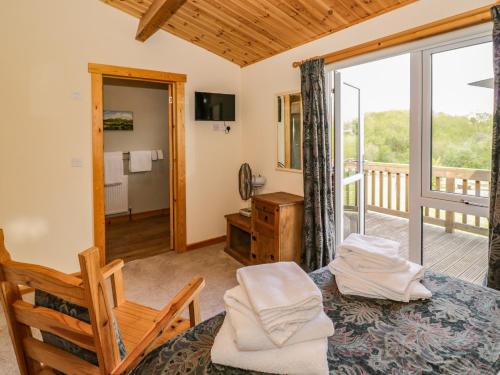a bedroom with a bed and a balcony at Brookside Lodge in Worcester