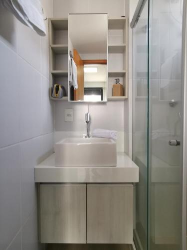 a bathroom with a sink and a shower at Boa Viagem - Charmoso apartamento para casais in Recife