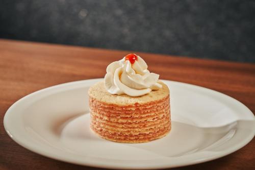 a piece of cake on a white plate on a table at Hotel Atlante Plaza in Recife