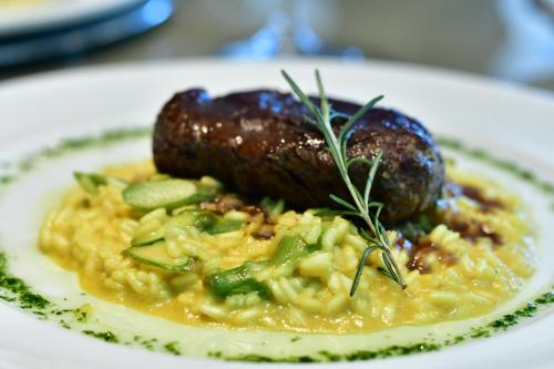 a plate of food with sausage and vegetables on a plate at Hotel Atlante Plaza in Recife